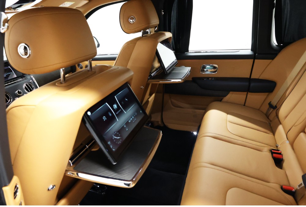 Rear entertainment system of white Rolls-Royce Cullinan Black Badge